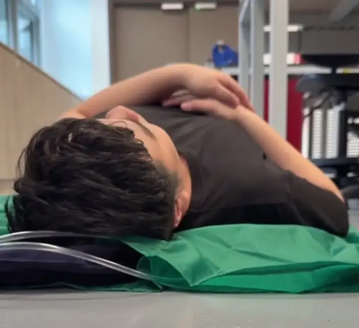 Participant lying on the InflatAssist prototype before side support inflation